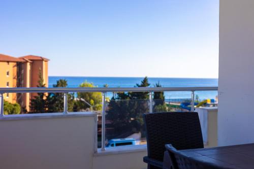 a balcony with a table and a view of the ocean at ALANYA KONAKLİ APART in Alanya