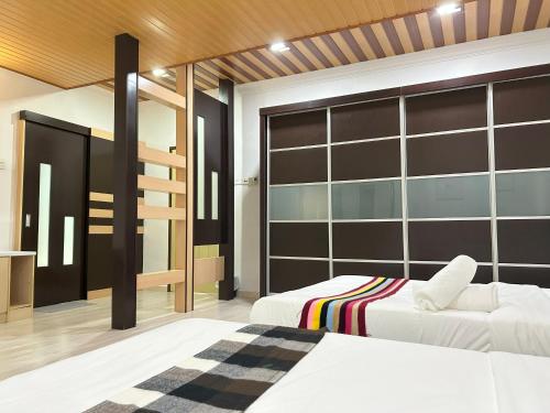 Ένα ή περισσότερα κρεβάτια σε δωμάτιο στο Life Art Home Family Ipoh Homestay 5R4B 18pax SY28