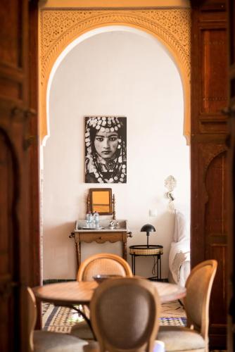 a dining room with a table and chairs at Riad Hanael Garden & Spa in Fès