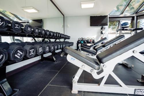 a gym with rows of dumbbells in a room at Lilleshall House & Gardens and Lilleshall National Sports Centre in Telford