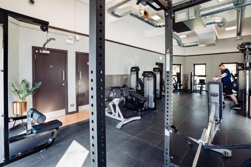 a man in a gym with several tread machines at Lilleshall House & Gardens and Lilleshall National Sports Centre in Telford