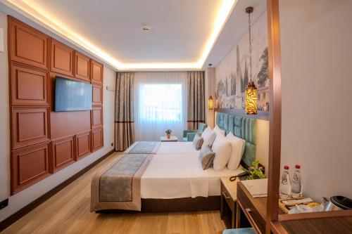 a hotel room with a bed and a television at Grand Hilarium Hotel in Istanbul