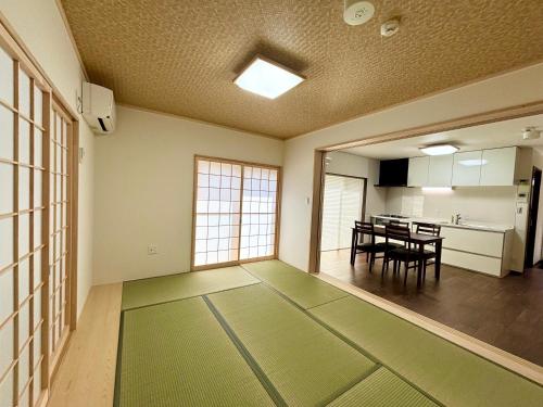an empty room with a table and a kitchen at Kyoto Station Lanshin in Kyoto