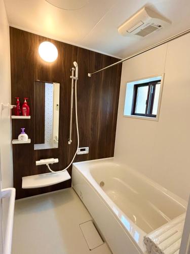 a bathroom with a bath tub and a shower at Kyoto Station Lanshin in Kyoto