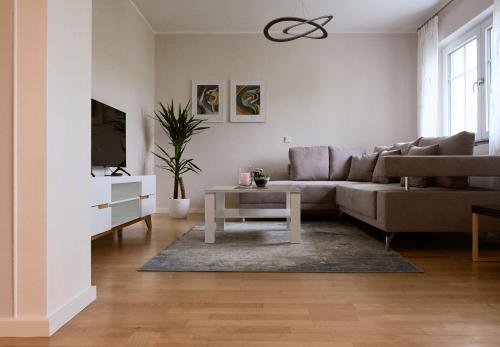 a living room with a couch and a table at Wein- u. Gästehaus St. Maximin in Leiwen