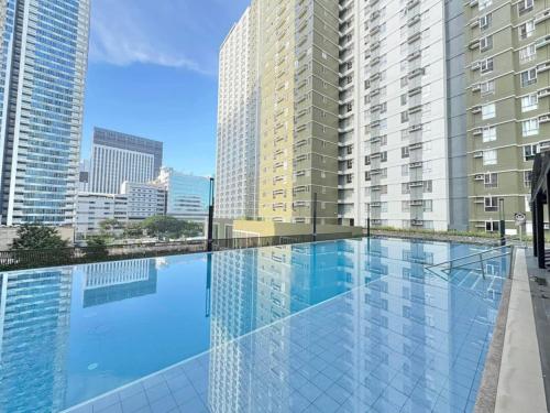 a large swimming pool on the roof of a building at Studio With Citylights and SEAview near MALL inside IT PARK in Sampong