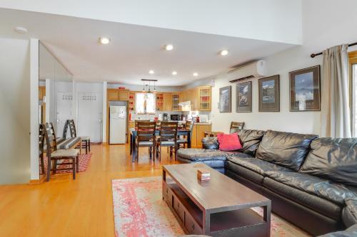 a living room with a leather couch and a table at Community Indoor Pool Tannersville Townhome in Tannersville