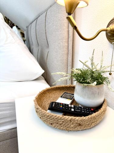 a bedside table with a remote control and a lamp at Bleibe am Moritzberg in Haimendorf