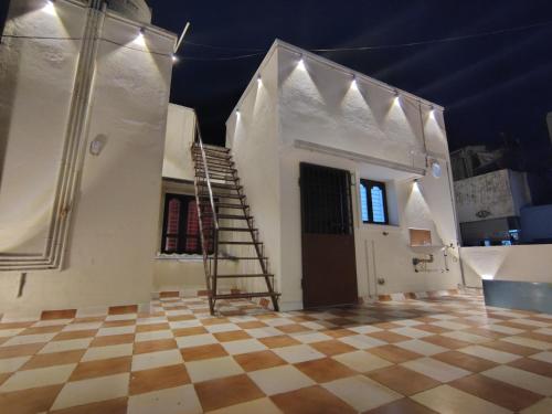 a room with a staircase and a room with a checkered floor at THE VILLA Pondicherry in Puducherry
