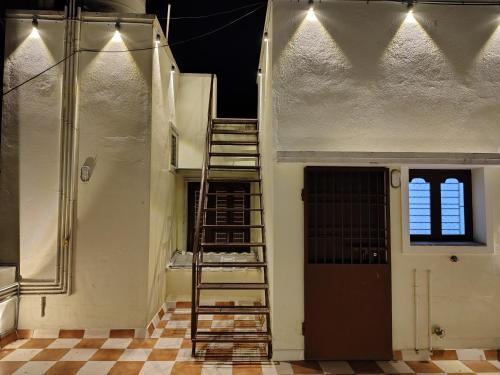 a staircase leading up to a building with a window at THE VILLA Pondicherry in Puducherry