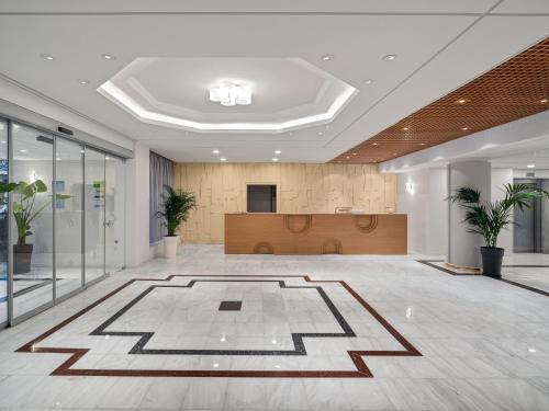 an office lobby with a large rug in the middle at Creta Royal - Adults Only in Skaleta