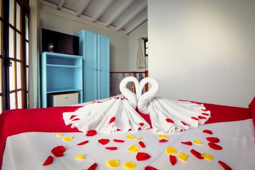 Katil atau katil-katil dalam bilik di VELINN Pousada Guarubela Villa Vittoria