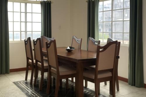 a dining room table and chairs with a table and windows at Vacation Home in San Ignacio, Belize - Sleeps 10 in San Ignacio