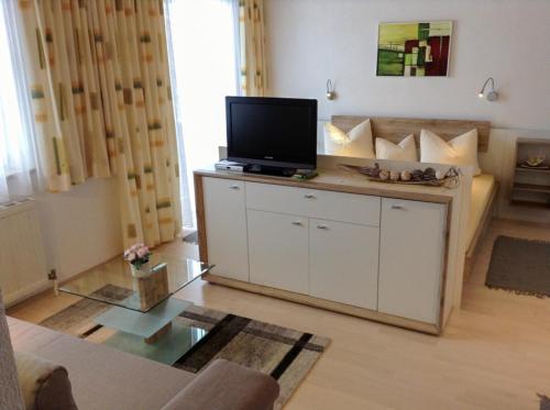 a living room with a flat screen tv on a counter at Apartmenthaus Brigitte in Leutasch