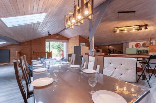 a large dining room with a long table and chairs at Villa À Isturits Avec Piscine in Isturits