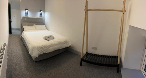 a small bed in a small room with a canopy bed at 'James Lyons' The old main St in Ballyhaunis