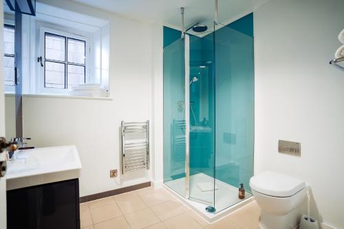 a bathroom with a glass shower and a toilet at Lilleshall House & Gardens and Lilleshall National Sports Centre in Telford