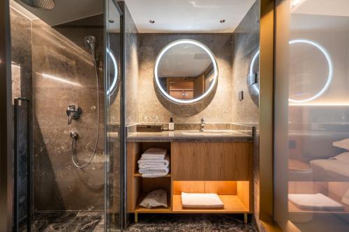 a bathroom with a shower and a sink and a mirror at Longji Vista Retreat--Panoramic View of Terrace, Sunrise ,Heated Pool & Affordable Luxury in Longsheng
