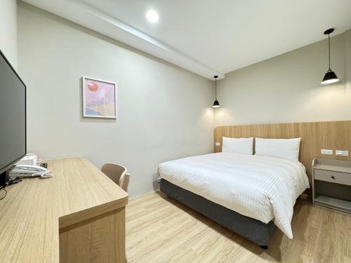 Un ou plusieurs lits dans un hébergement de l'établissement Yoshi Hotel - Tainan Sinmei Branch
