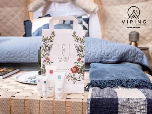 a table with some products on top of a bed at Bramslev Bakker Naturhotel in Hobro