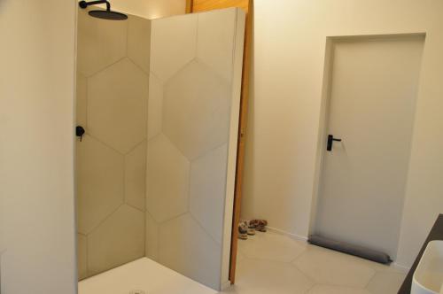 a shower with a glass door in a bathroom at Minimal design villa Free parking Garden in Palazzina