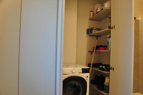 a laundry room with a washer and a washing machine at Minimal design villa Free parking Garden in Palazzina