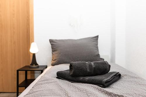 a bed with two pillows sitting on top of it at CosyHomes24 - centrally with balcony and garage - IL01b in Iserlohn