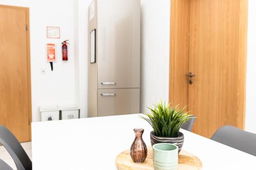 a dining room with a table with a plant on it at CosyHomes24 - centrally with balcony and garage - IL01b in Iserlohn