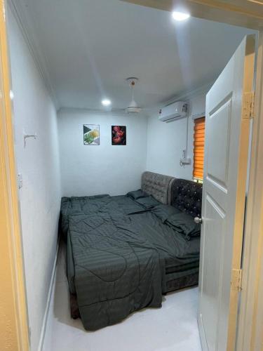 a bedroom with a bed in a small room at TFC Studio in Kuala Terengganu