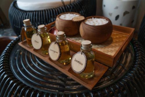 a tray with four bottles of oil on a table at Casa Maddu in Tegalalang