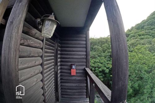 a wooden cabin with a red box on the side at IST Villa 05 Mountain Hideout in Wada