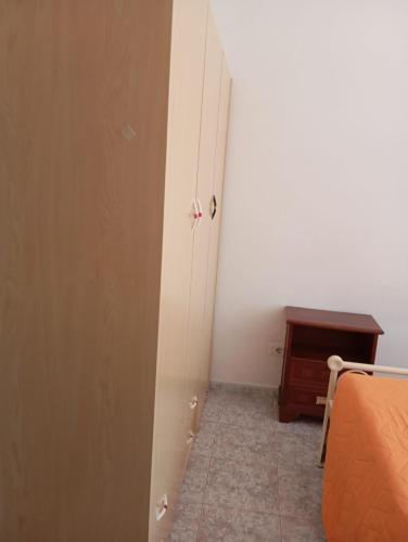 an open door to a room with a bed and a desk at PM 135 Corso Umberto Guest House in Cuglieri