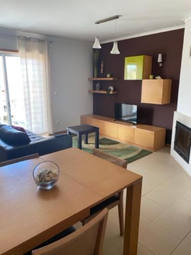 a living room with a table and a dining room at Apart. Dunas da Torreira in Torreira