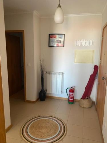 a living room with a rug on the floor of a room at Apart. Dunas da Torreira in Torreira