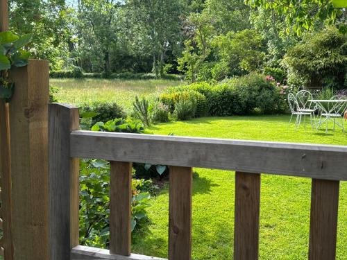 a wooden fence with a garden in the background at Pandy B&B in Dorstone