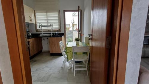 a kitchen and dining room with a table and chairs at Luxury family villa in Casablanca