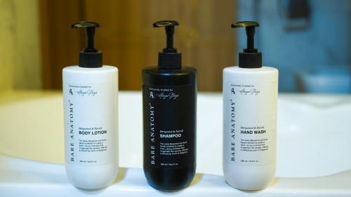 a group of three shampoo bottles sitting on a table at Emperor Ozran by Alaya Stays in Vagator