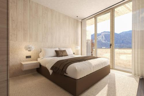 a bedroom with a large bed and a large window at Torghele's Wald & Fluh in Balderschwang