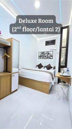 a bedroom with a bed and a sign that reads believe room floor at Laswi Syariah Guest House in Bandung