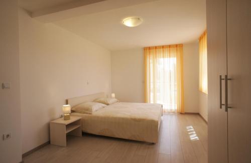 a bedroom with a large bed and a window at Spacious apartment sleeps 4 by the beach in Medulin