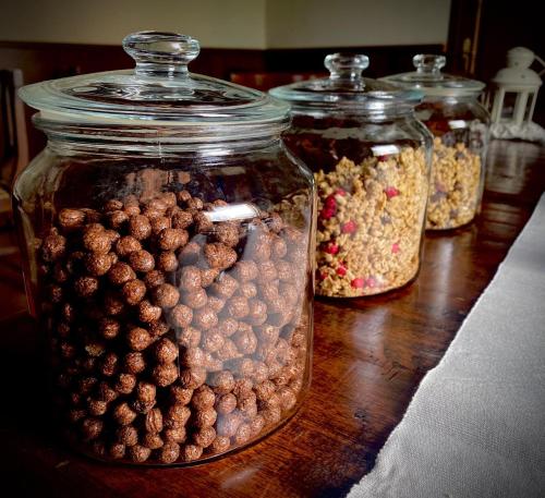 four glass jars filled with nuts on a wooden table at Agriturismo La Bisa in Trecenta