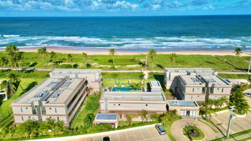 an aerial view of a resort near the beach at Apartamento Pé na Areia Cond Alphaville Guarajuba in Camaçari