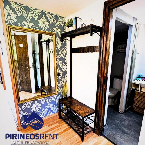 a room with a mirror and a shelf in a room at Apartamentos Pirineos Rent in Candanchú