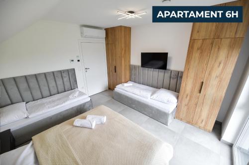 a living room with two beds and a table at Słoneczne Wzgórze Zator in Zator