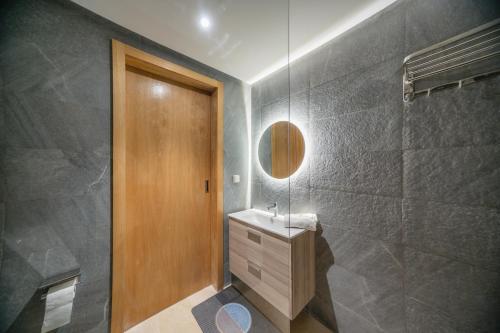 a bathroom with a sink and a mirror at Appartement Taghazout Bay in Taghazout