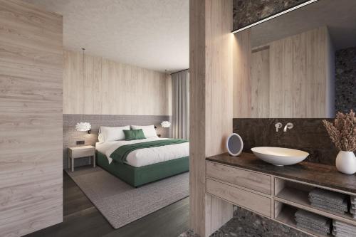 a bedroom with a bed and a bathroom with a sink at Torghele's Wald & Fluh in Balderschwang