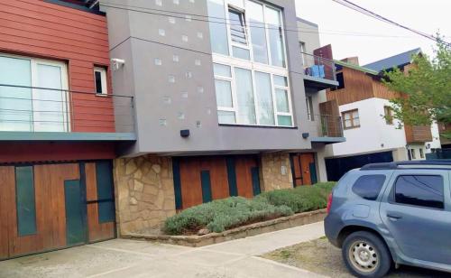 a car parked in front of a building at Departamento Costa Ramayon in San Martín de los Andes