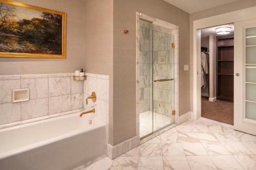 a bathroom with a tub and a shower at Willard InterContinental Washington by IHG in Washington