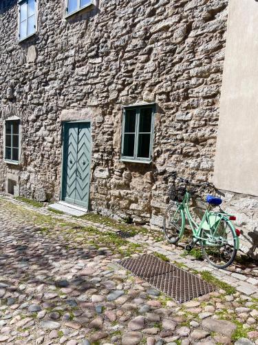a green bike parked next to a stone building at Newly renovated 2 bedroom apartment in Visby