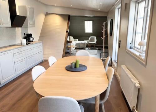 a kitchen and dining room with a wooden table and chairs at Newly renovated 2 bedroom apartment in Visby